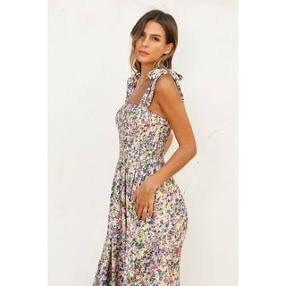 Woman wearing a floral dress against a white background